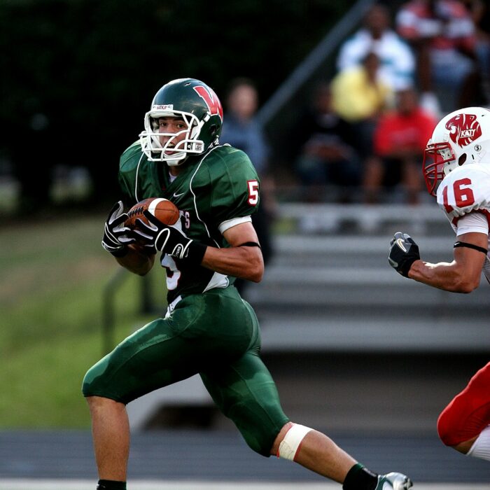 American football player wearing a green team uniform