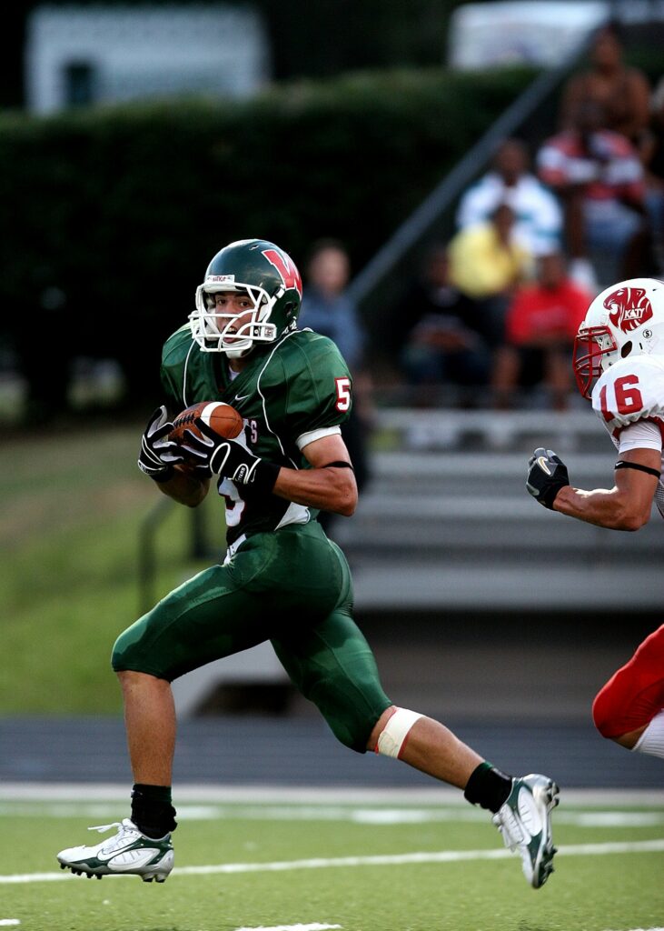 American football player wearing a green team uniform