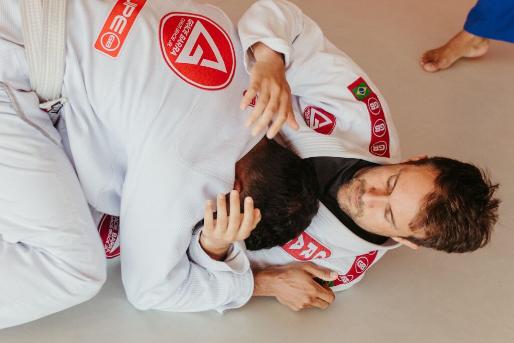Athletes practicing grappling in martial arts uniforms
