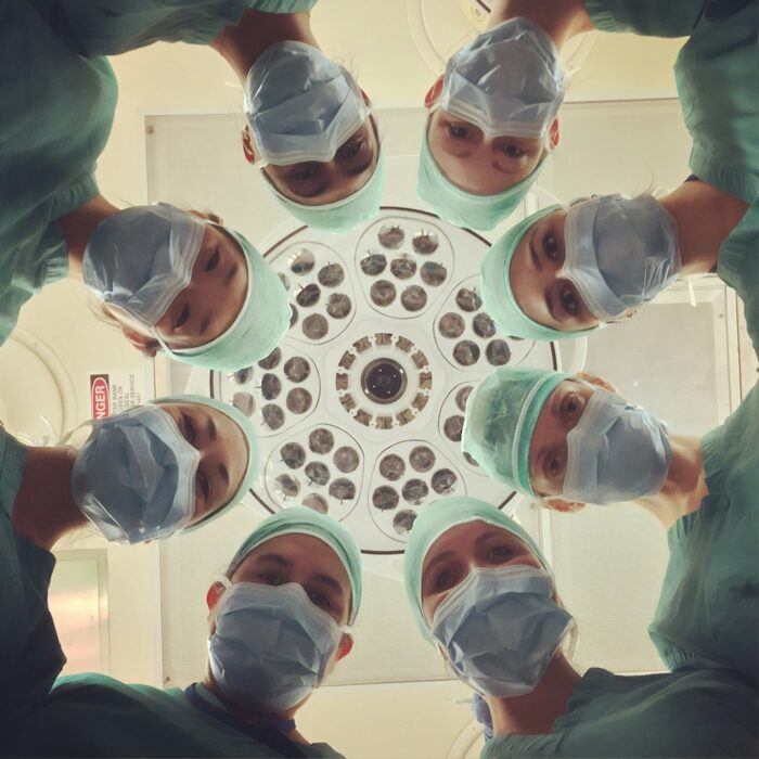 Illustrative medical uniform photograph by National Cancer Institute, Unsplash