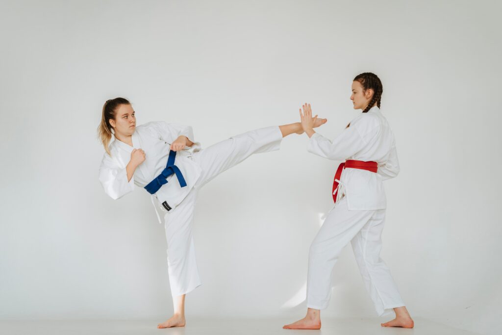 Two athletes training in white martial arts uniforms