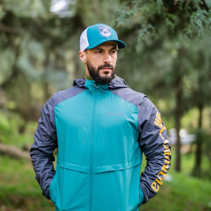 Model wearing a teal and grey hooded jacket