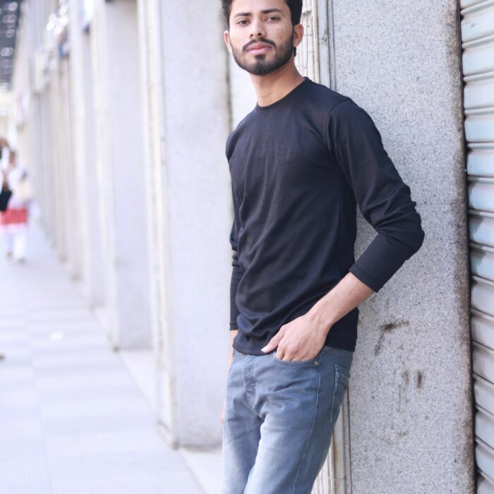 Man wearing a plain black long-sleeve crew-neck T-shirt; illustrative style reference by Muhammad Numan on Unsplash, not a Grato-produced garment