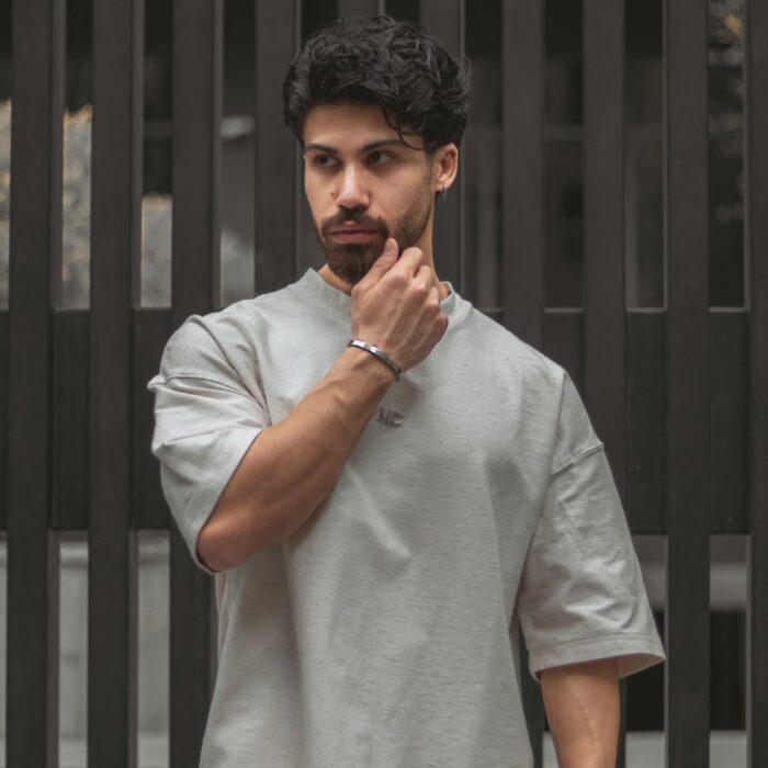 Grey loose short-sleeve T-shirt with a raised collar on a model; illustrative style reference