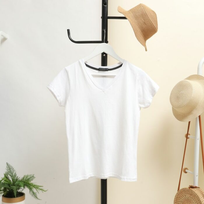 White short-sleeve V-neck T-shirt on a hanger; illustrative style reference